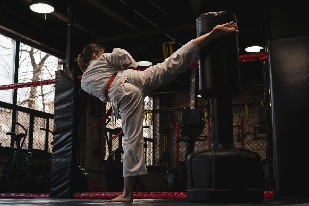 A student working combinations on a heavy bag